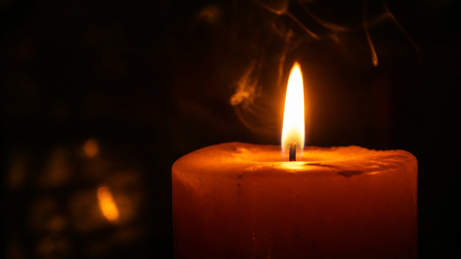 A single bright candle flame in the dark, evoking the intensity of a twin flame versus a soulmate